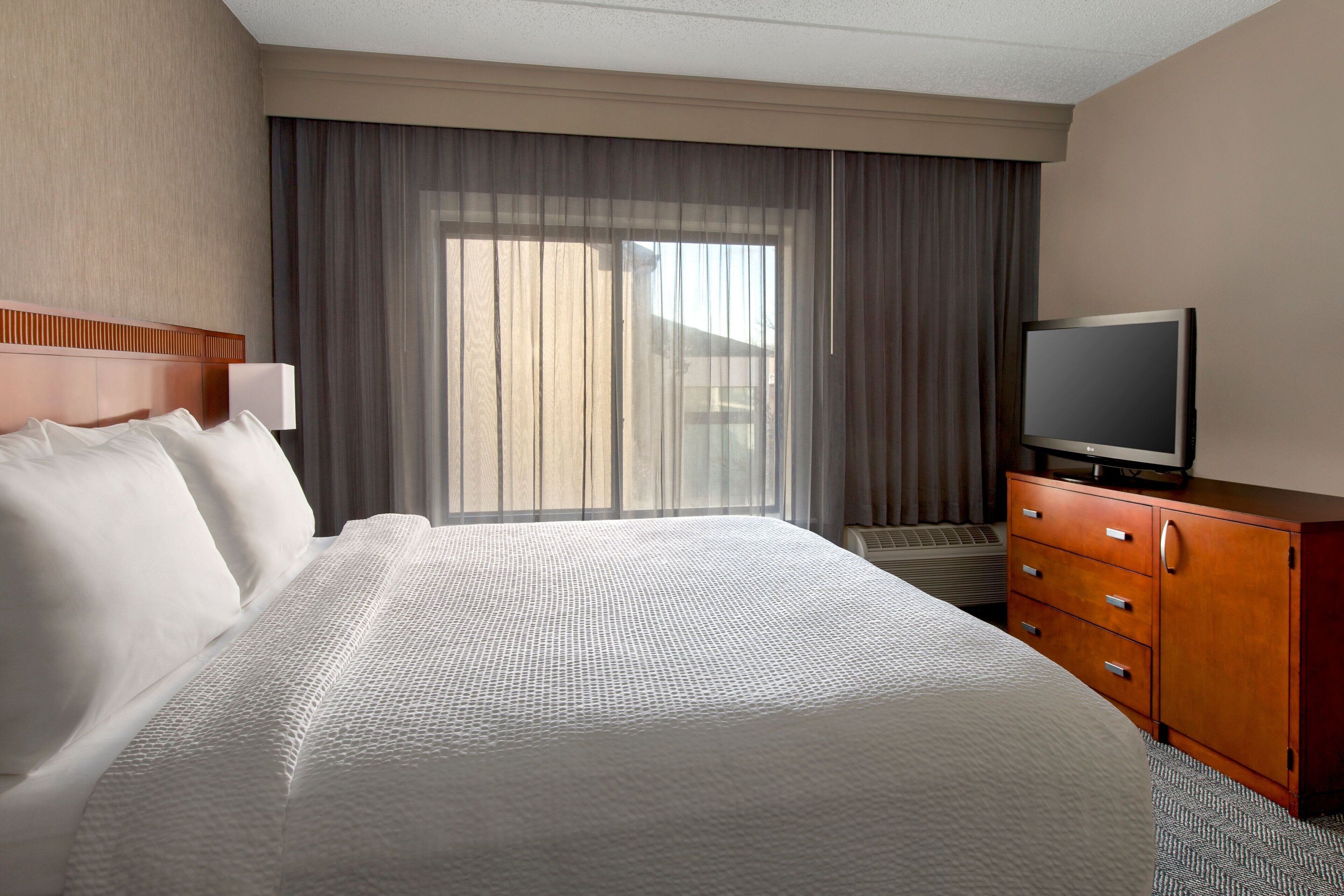 premium bedding, pillow-top beds, desk, laptop workspace