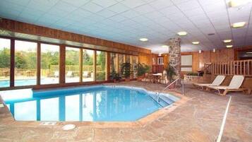 Relax by the pool surrounded by a high ceiling and large windows.