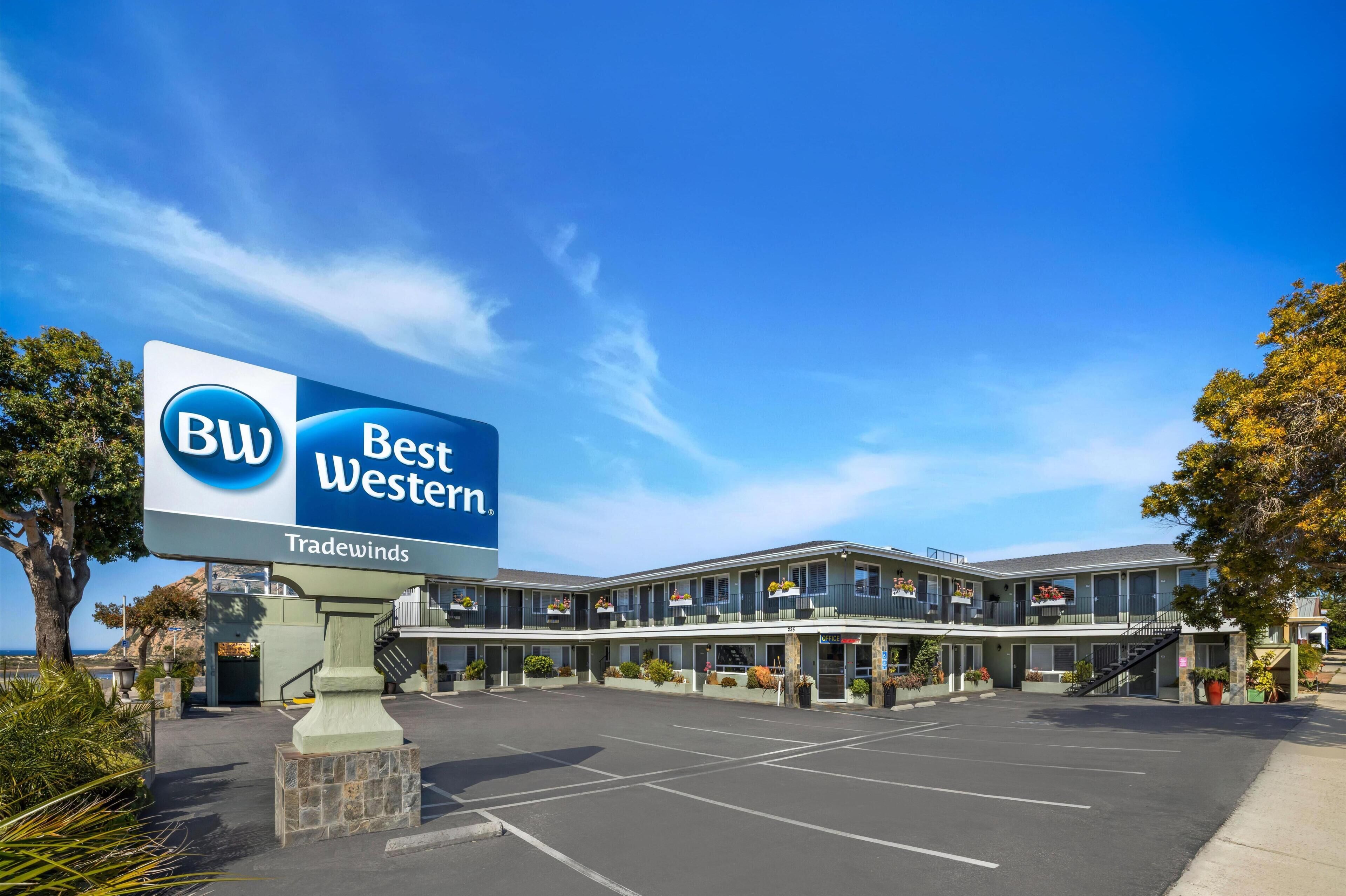 Ett Best Western-hotell med en stor skylt, en parkeringsplats och en byggnad med flera balkonger.