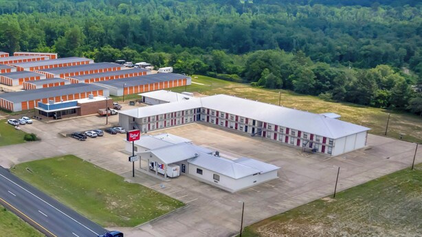 A large industrial building with multiple parking lots and a road in the foreground.