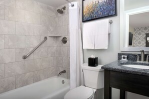 A bathroom with a bathtub, toilet, and sink. - West End Washington DC, Tapestry Collection by Hilton (Washington)