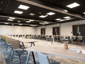 A conference room with long tables, chairs, and ceiling-mounted projectors. - Novotel Rouen Sud Zenith Parc Expo (Saint-Etienne-du-Rouvray)