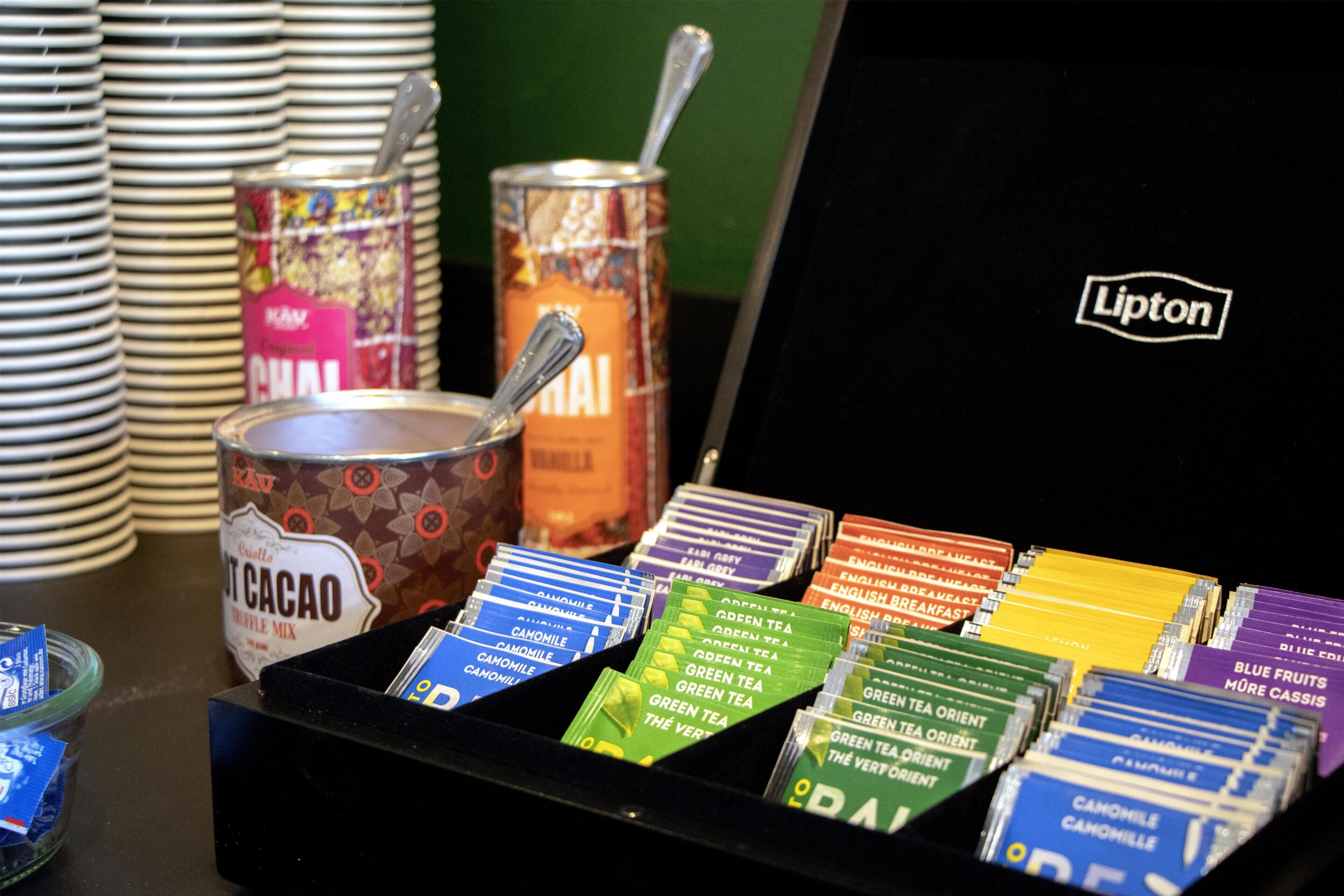 A variety of tea and food items in a box with a Lipton logo.