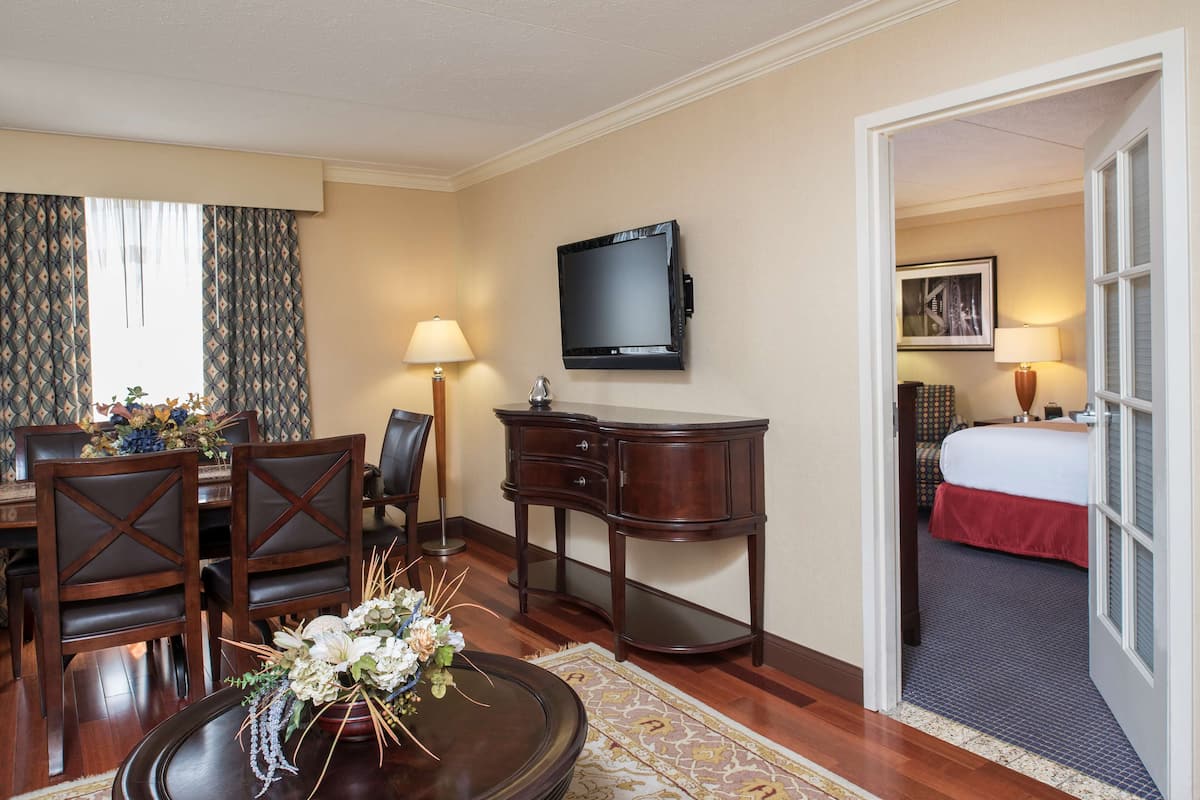 junior suite, 1 king bed | living area | 32-inch tv with satellite channels, ipod dock