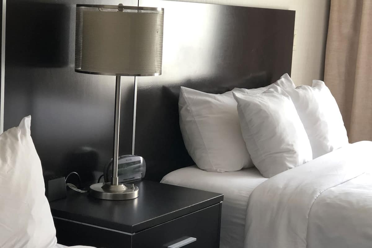 Desk, laptop workspace, iron/ironing board, bed sheets