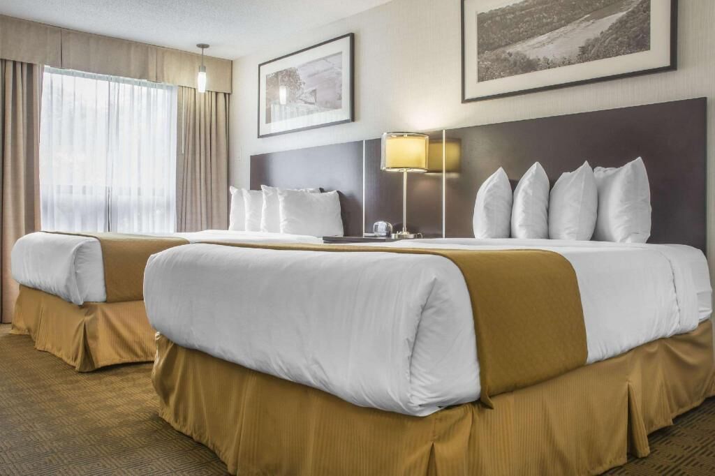 Desk, laptop workspace, iron/ironing board, bed sheets