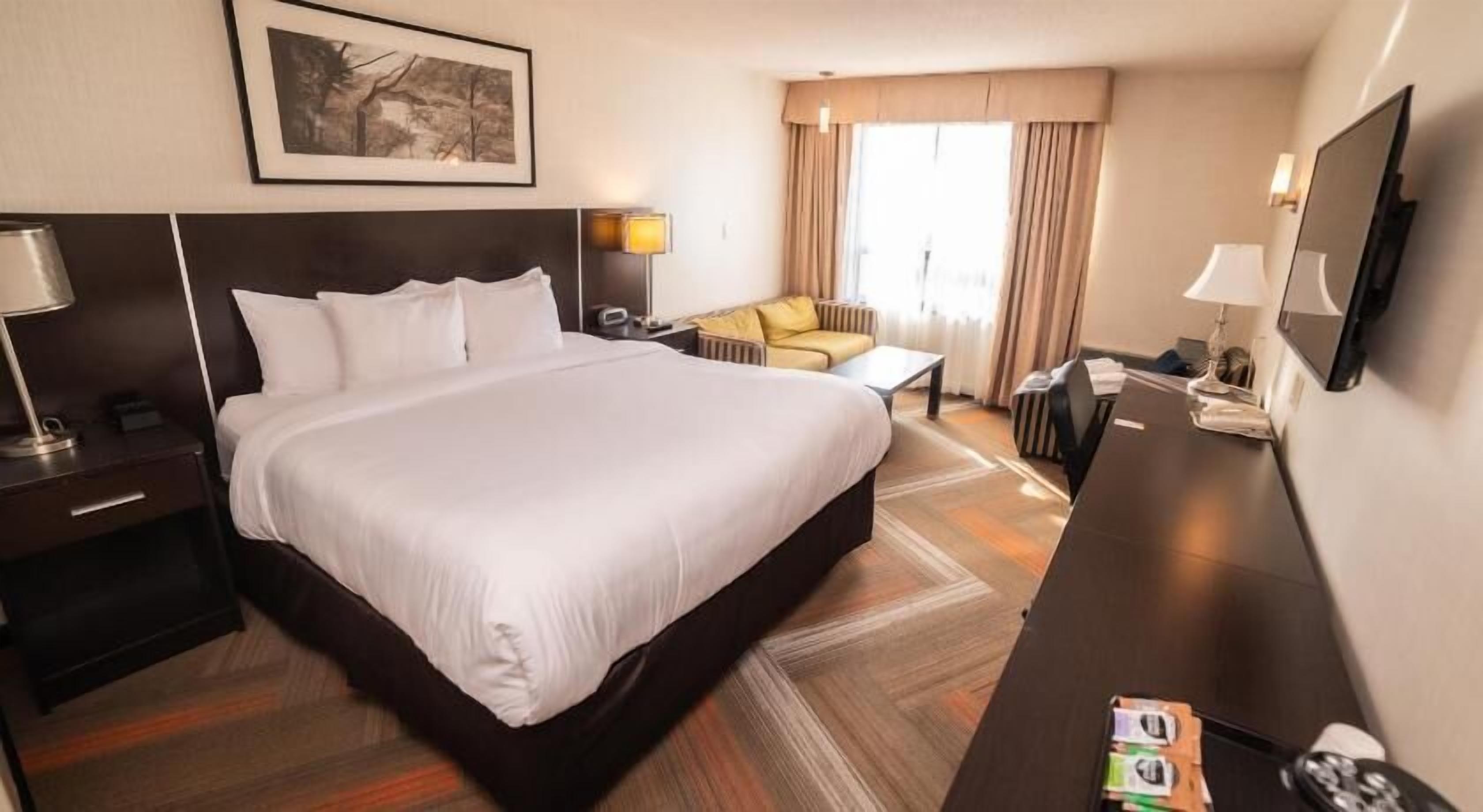 Desk, laptop workspace, iron/ironing board, bed sheets