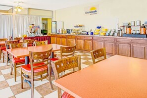 Enjoy a warm breakfast in our inviting breakfast area, featuring a selection of fresh food and a variety of seating options.