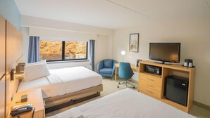 A hotel room with two beds, a desk with a television, a microwave, and a small refrigerator. - Elimwood Hotel, a Ramada by Wyndham (Maryland Heights)