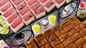 A variety of desserts and beverages arranged on a tray.