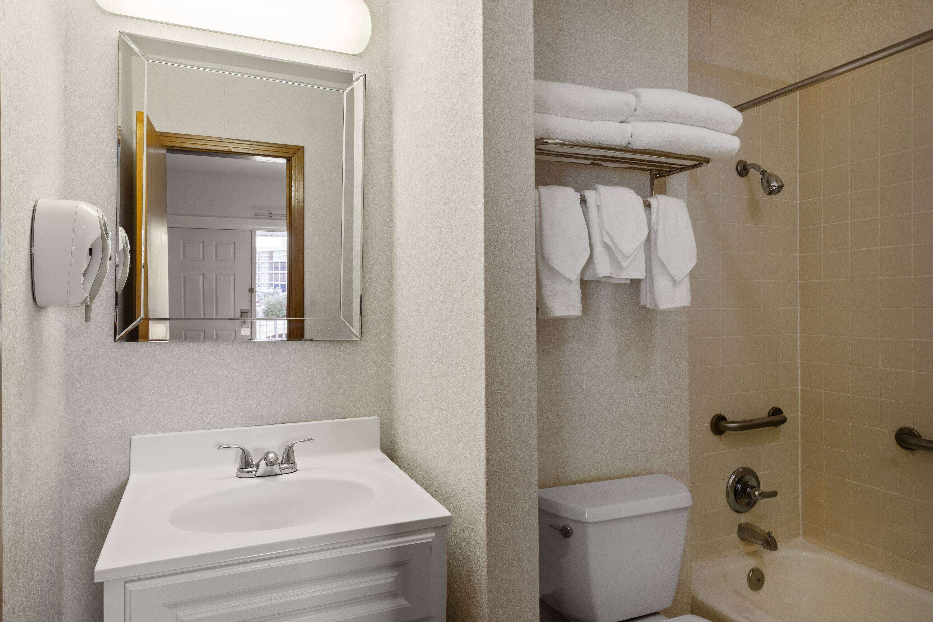 A bathroom with a sink, toilet, and shower.