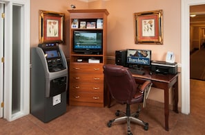A room with a desk, a computer, an ATM, a printer, and a minibar. - Travelodge by Wyndham Beckley (Beckley)