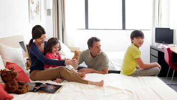 Family-friendly room with a large window, flat-screen TV, and comfortable seating area.