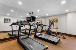 A gym with treadmills, a stationary bike, and a rowing machine. - Sleep Inn Beaver - Beckley (Beaver)