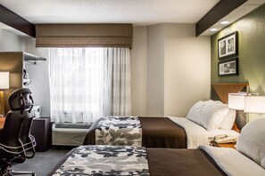 A hotel room with two beds, a desk, a chair, an air conditioning unit, and a window with sheer curtains. - Sleep Inn Beaver - Beckley (Beaver)