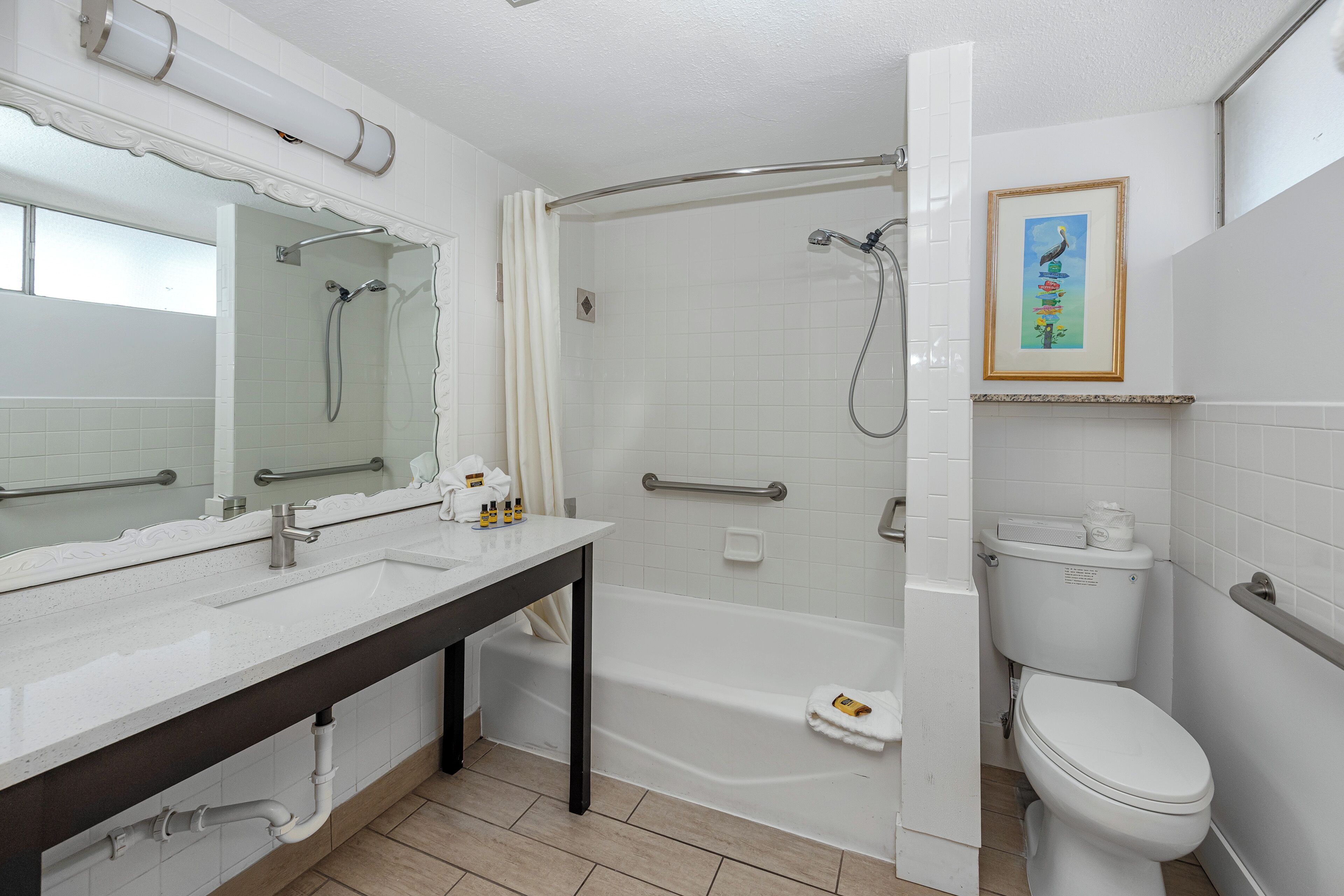 A bathroom with a bathtub, toilet, and sink.