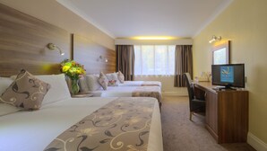 A hotel room with two beds, a desk, a television, and a window with curtains. - Cobden Hotel Birmingham (Birmingham)
