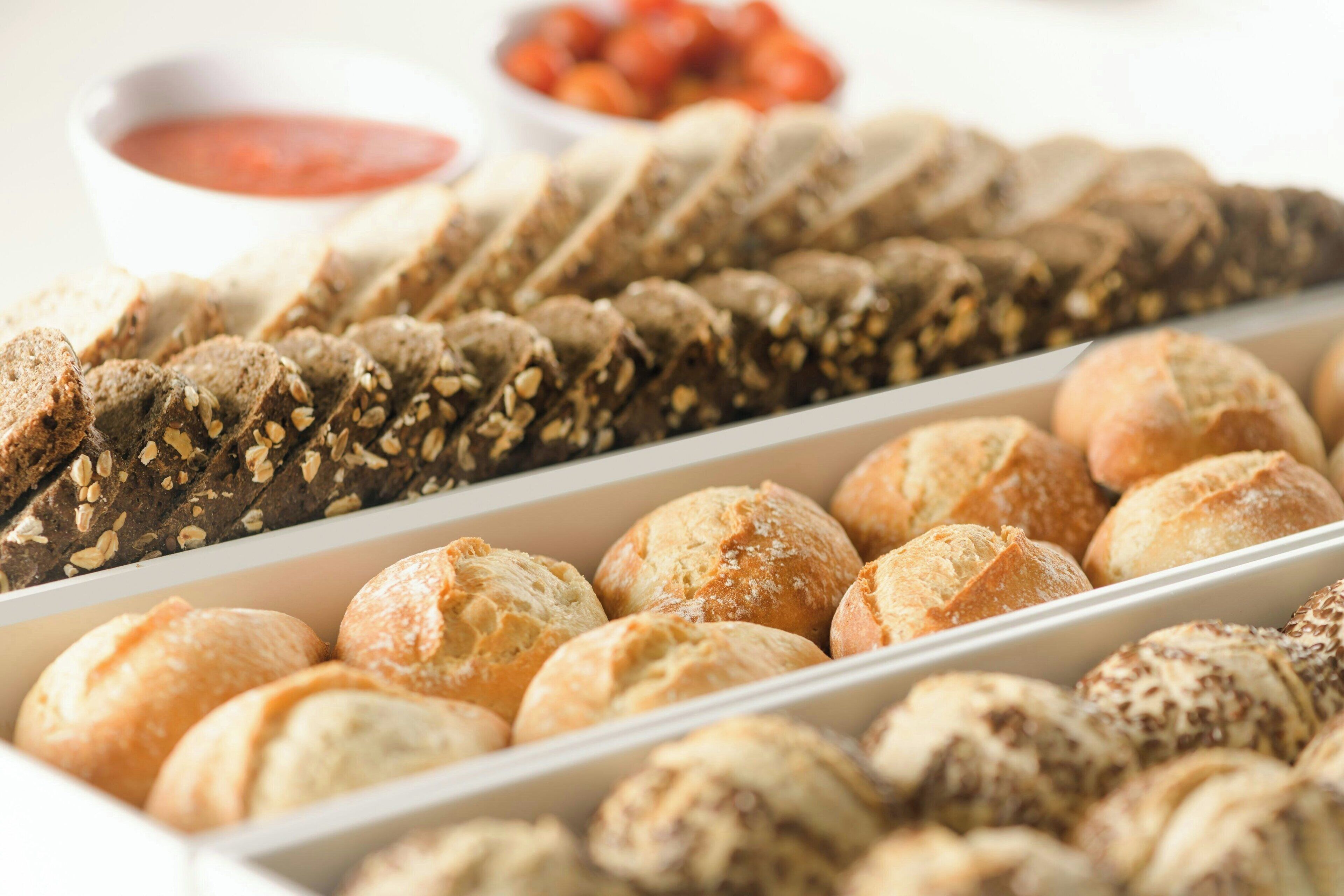 A variety of breads and pastries in a display case.