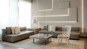 A modern living room with a sofa, a coffee table, and a chair.