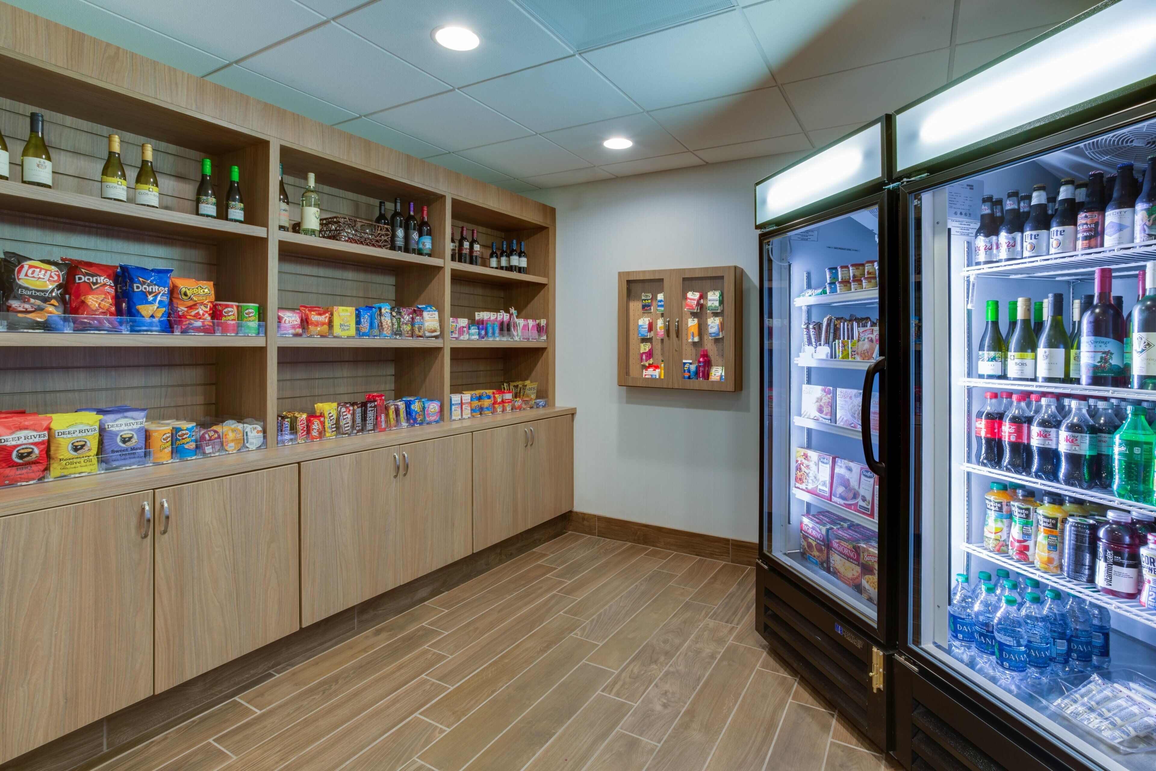 A snack and beverage section with shelves stocked with chips, snacks, and bottled drinks.