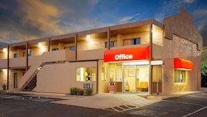 A two-story building with an 'Office' sign, a staircase, and a parking lot. - Knights Inn Page (Page)