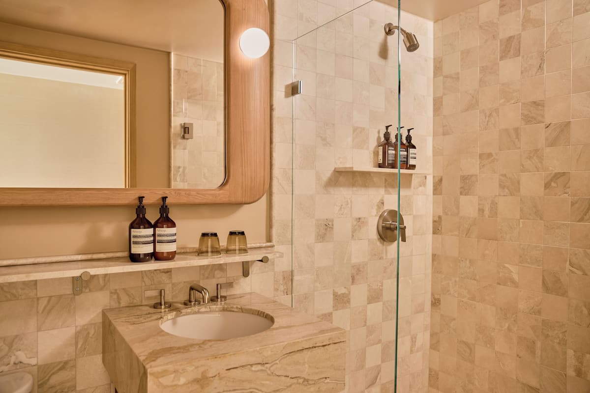 Shower, designer toiletries, hair dryer, bathrobes