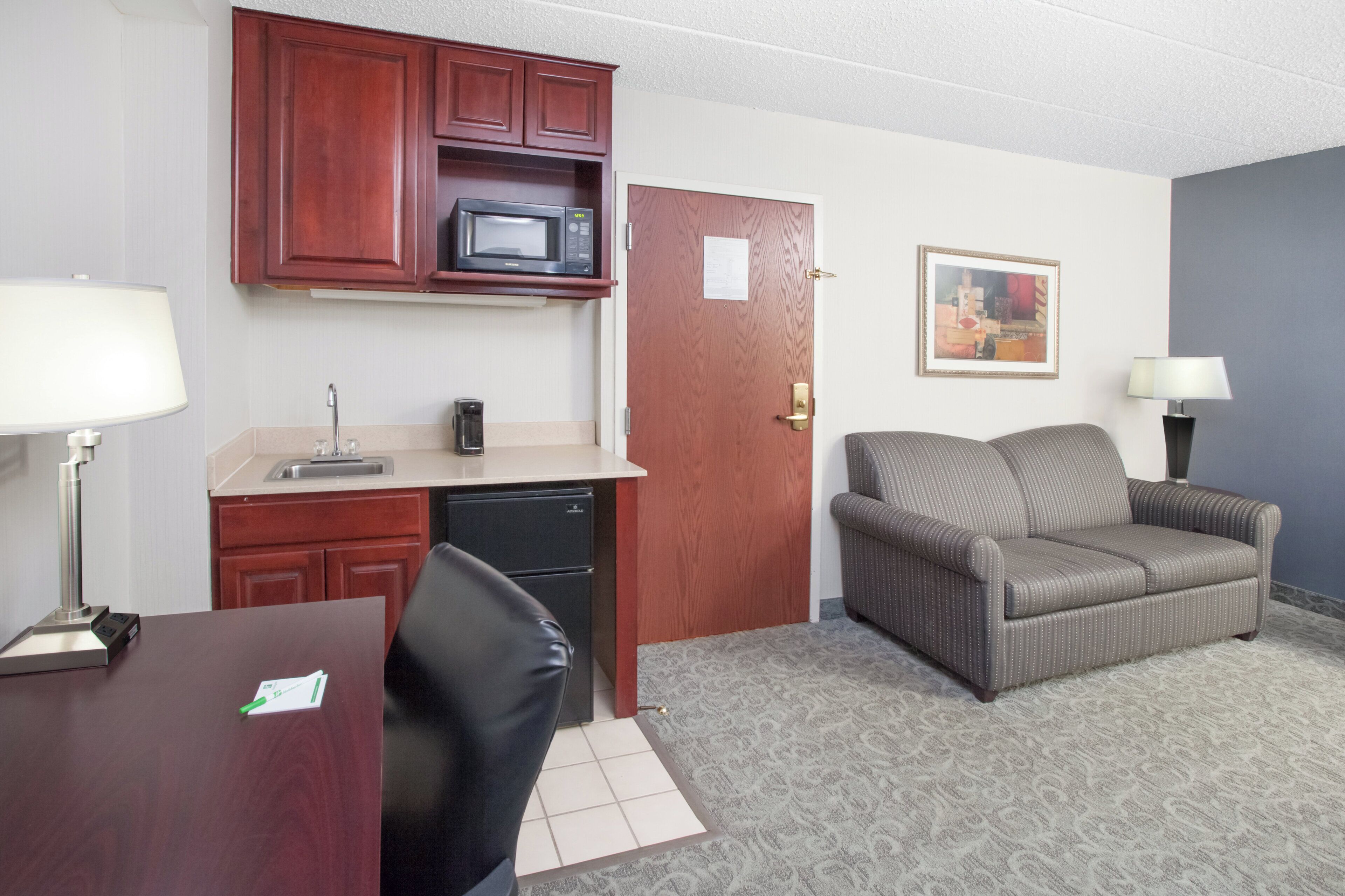 A compact living space with a kitchenette, a dining area, and a seating area.