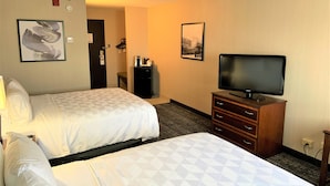 A hotel room with two beds, a television, a dresser, and a coffee machine. - Holiday Inn & Suites Chicago-Carol Stream (Wheaton) by IHG (Carol Stream)