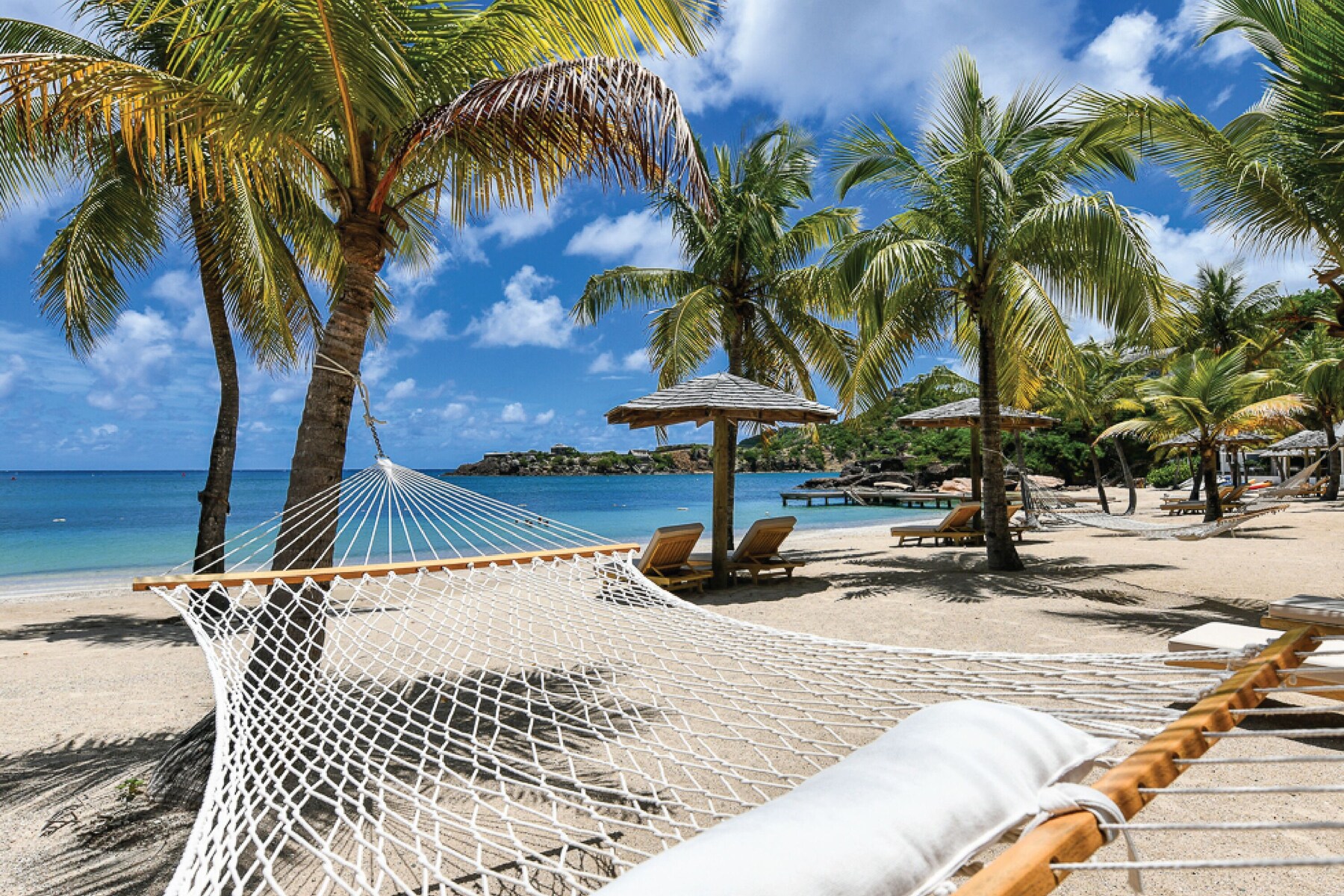 On the beach, white sand, sun-loungers, beach umbrellas