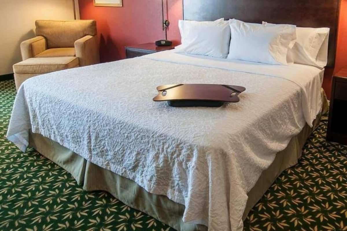 Premium bedding, desk, laptop workspace, blackout curtains