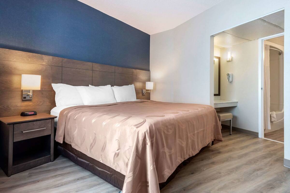 Premium bedding, desk, laptop workspace, iron/ironing board