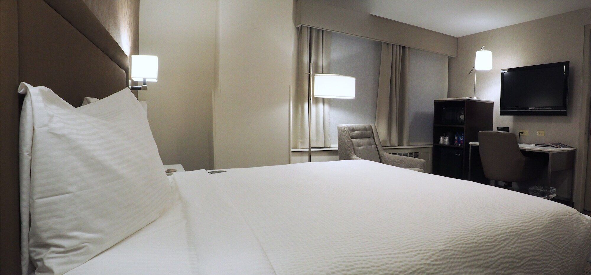 Premium bedding, desk, laptop workspace, blackout drapes