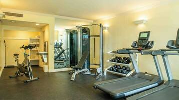 A gym with treadmills, an elliptical, and a weight machine.
