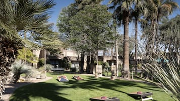 Relax in a serene outdoor space surrounded by lush greenery and modern architecture.