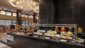 A buffet area with various food options and a chandelier.