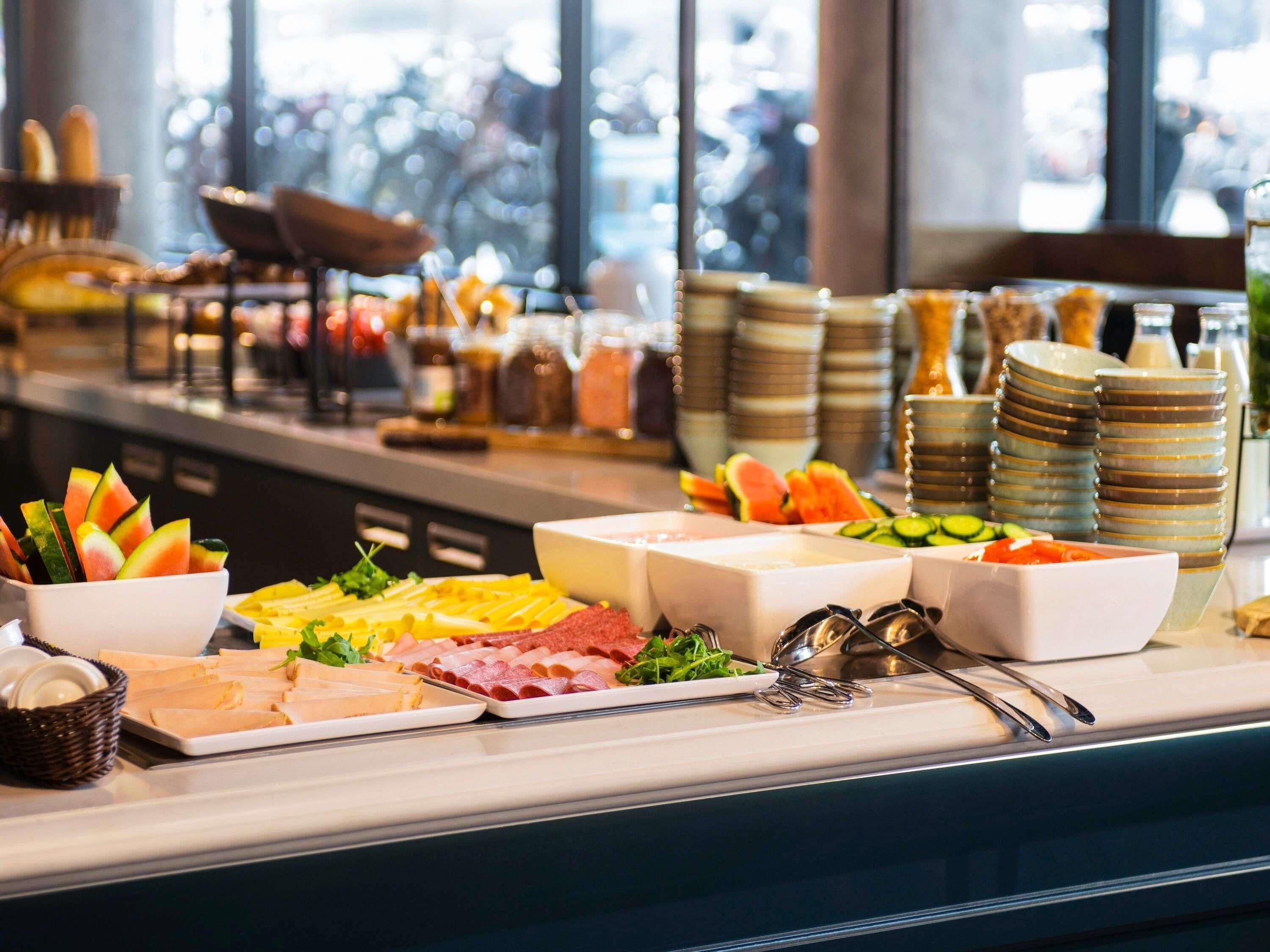 A buffet with various food items and utensils.