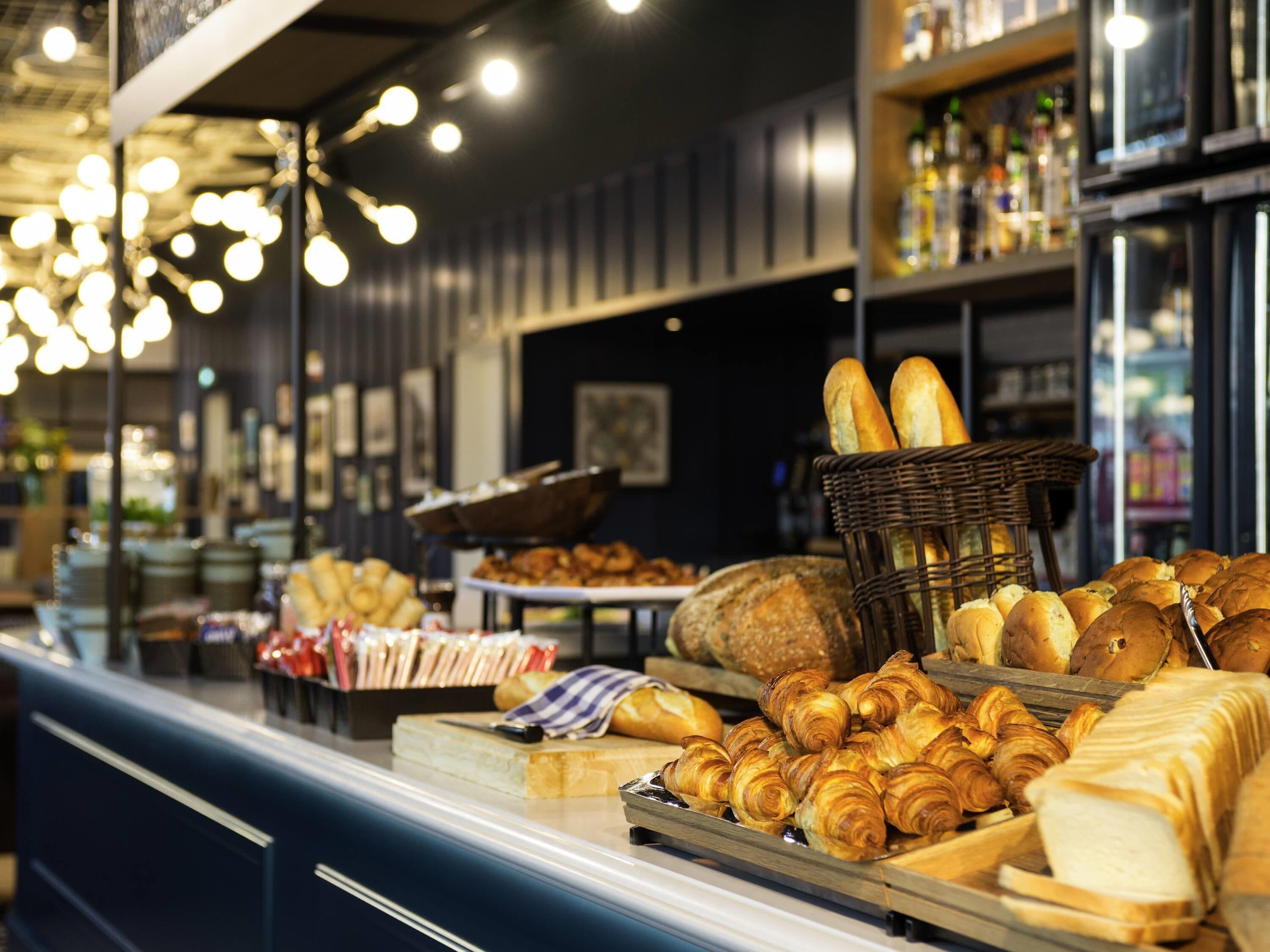 A bakery display with various breads and pastries.