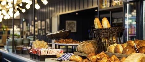 A bakery display with various breads and pastries.
