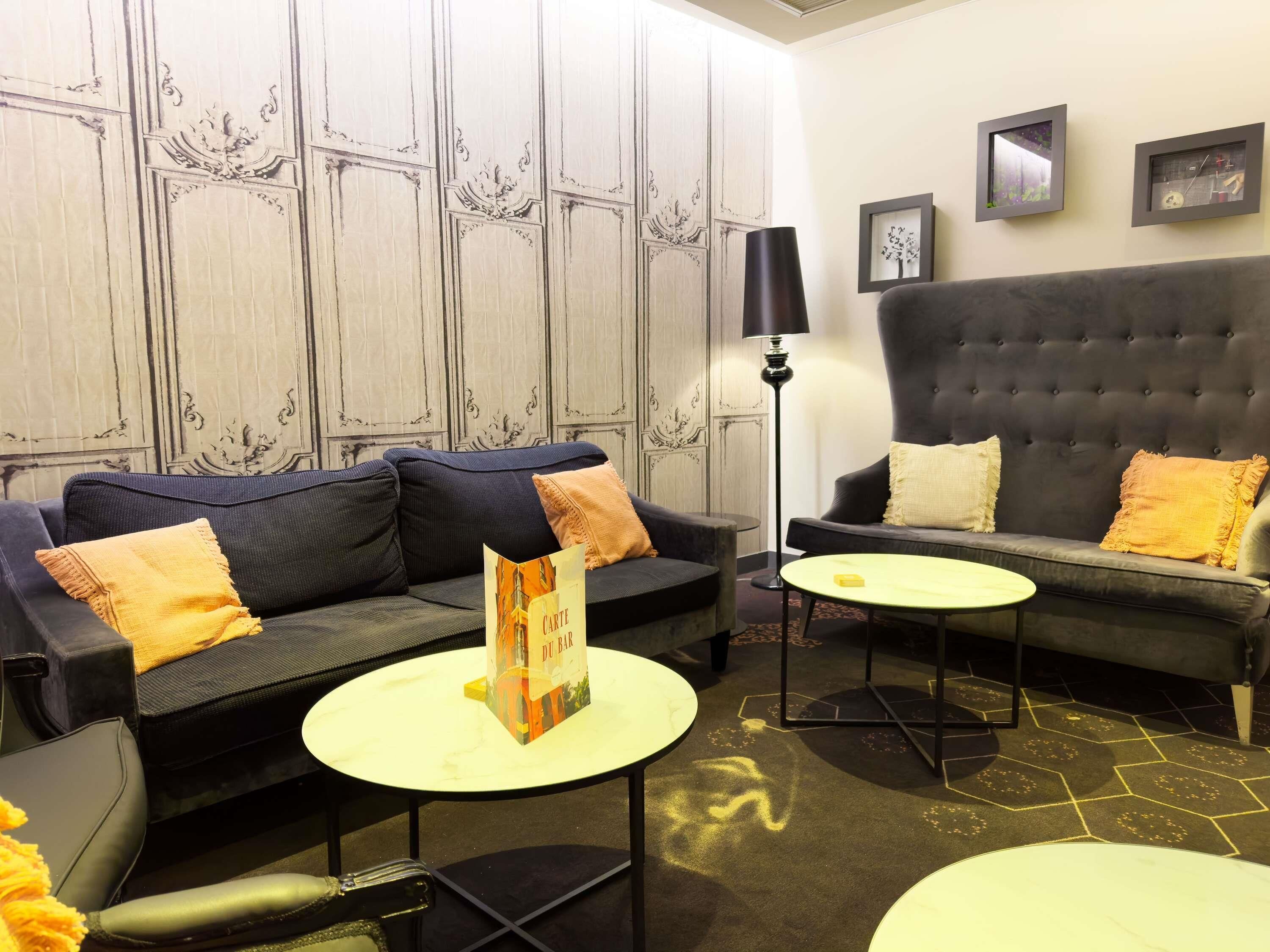 A modern living room with two sofas, a coffee table, and a floor lamp.
