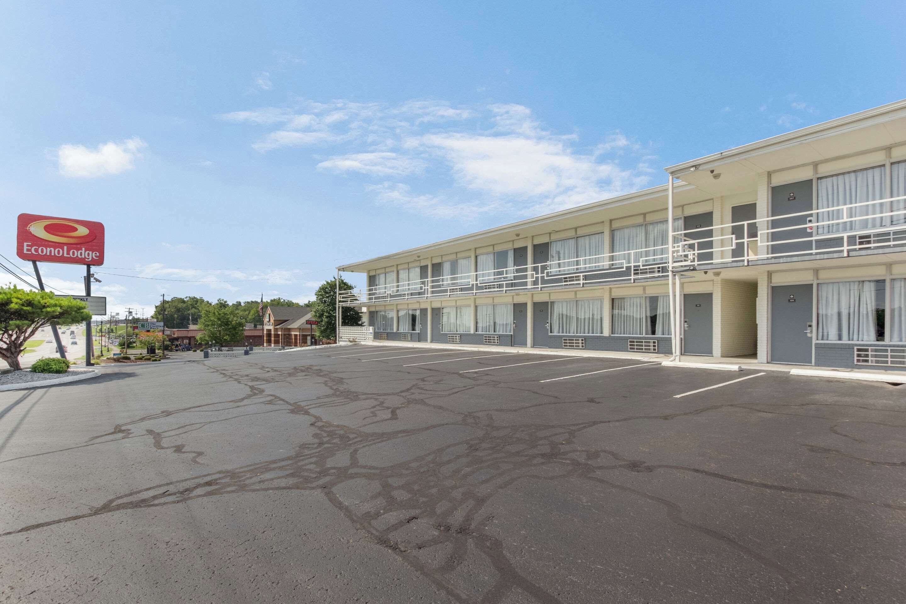 A two-story motel with a parking lot in front.