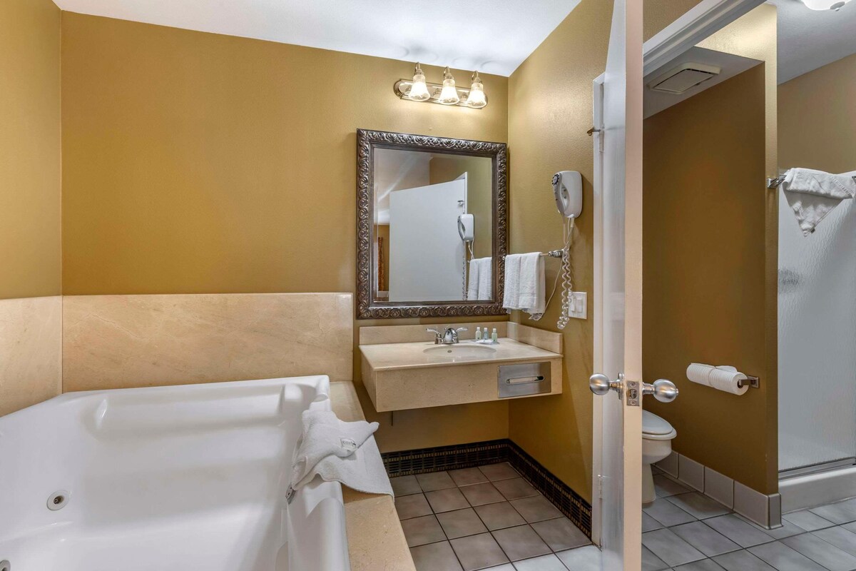 A bathroom with a bathtub, sink, and toilet.