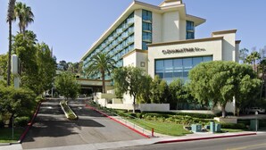 A modern hotel with a flat roof, large windows, and a sign reading "DOLLYWOOD HOTEL".