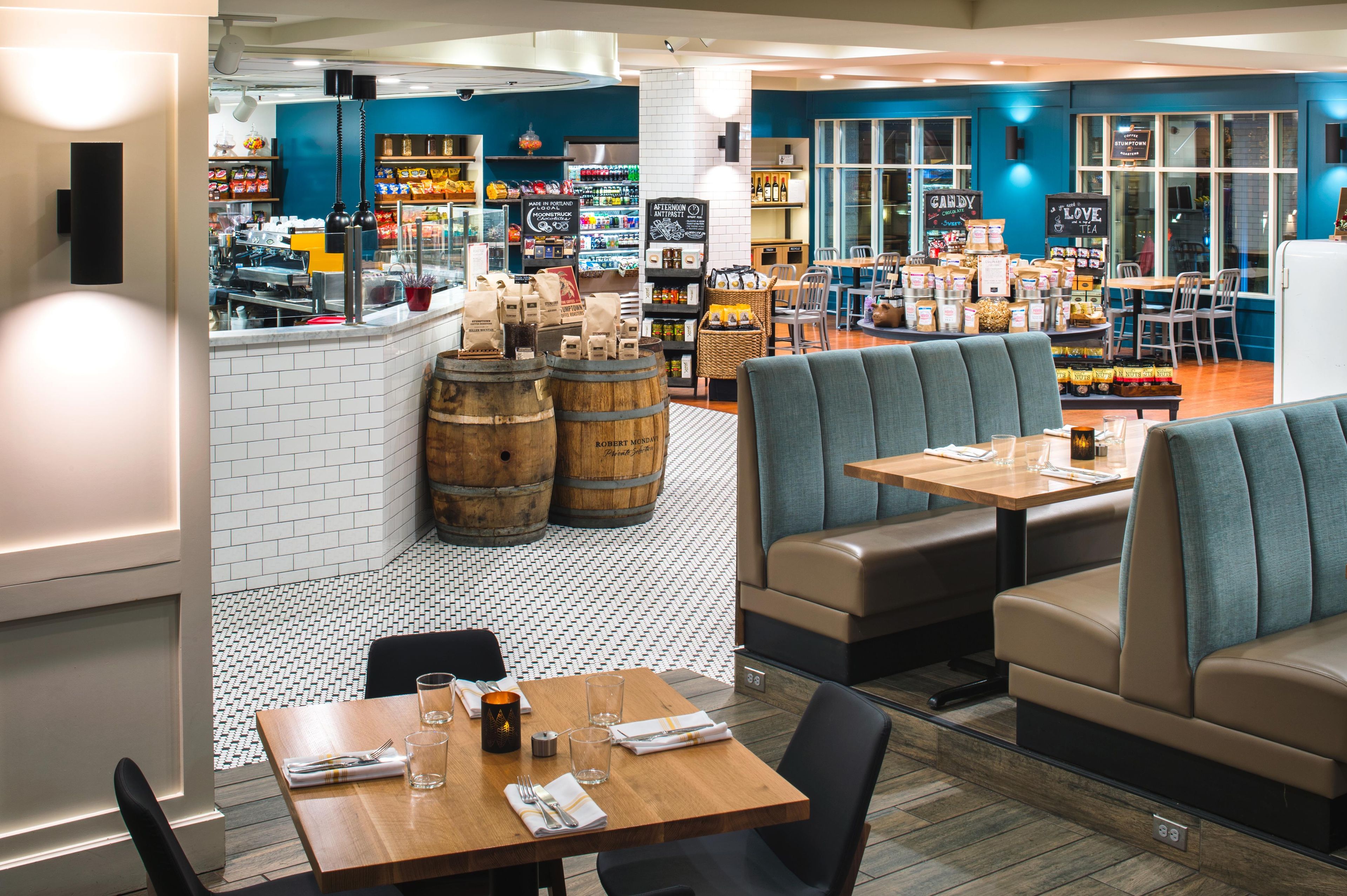 A restaurant interior with booths, tables, and a bar area.