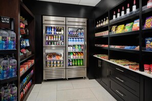 A grocery store with refrigerated sections, snack shelves, and bottled beverages. - Hyatt Regency Suites Atlanta Northwest (Marietta)