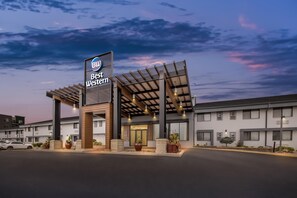 A hotel with a modern design, featuring a prominent sign, covered parking, and a well-maintained exterior. - Best Western West Towne Suites (Madison)