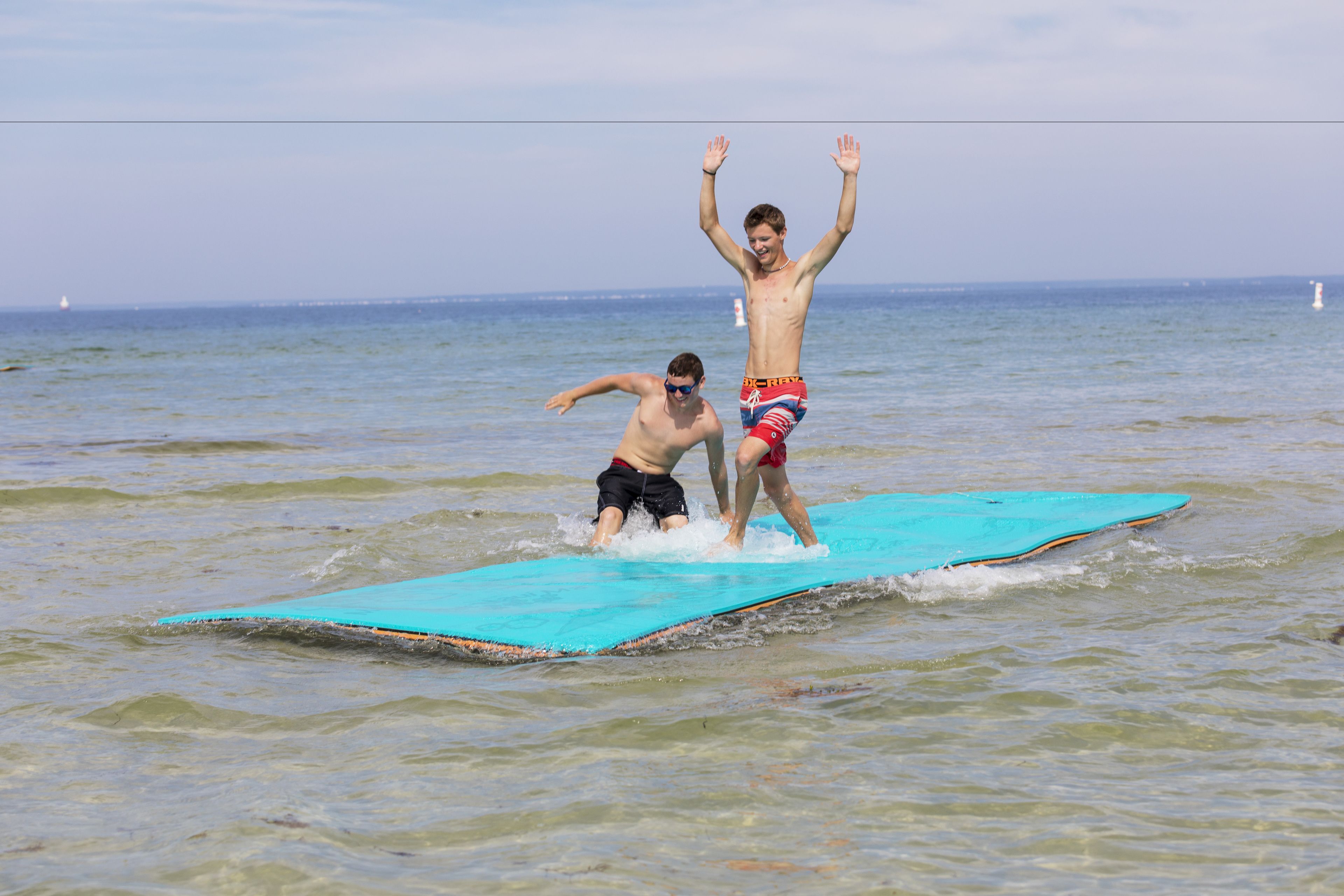 Two people on a surfboard in the ocean.
