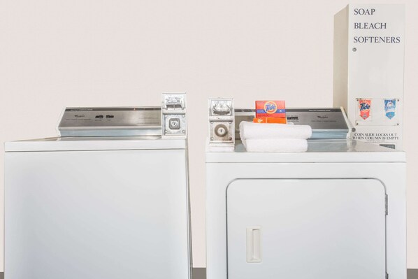 Two front-loading washing machines with detergent and fabric softener on top.