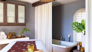 Relax in a stylishly designed room with a comfortable bed, bedside table, and large mirror.