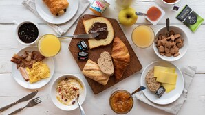 A breakfast table with various food items and condiments. - B&B HOTEL Perpignan Nord (Perpignan)