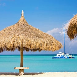 On the beach, white sand, beach cabanas, sun loungers